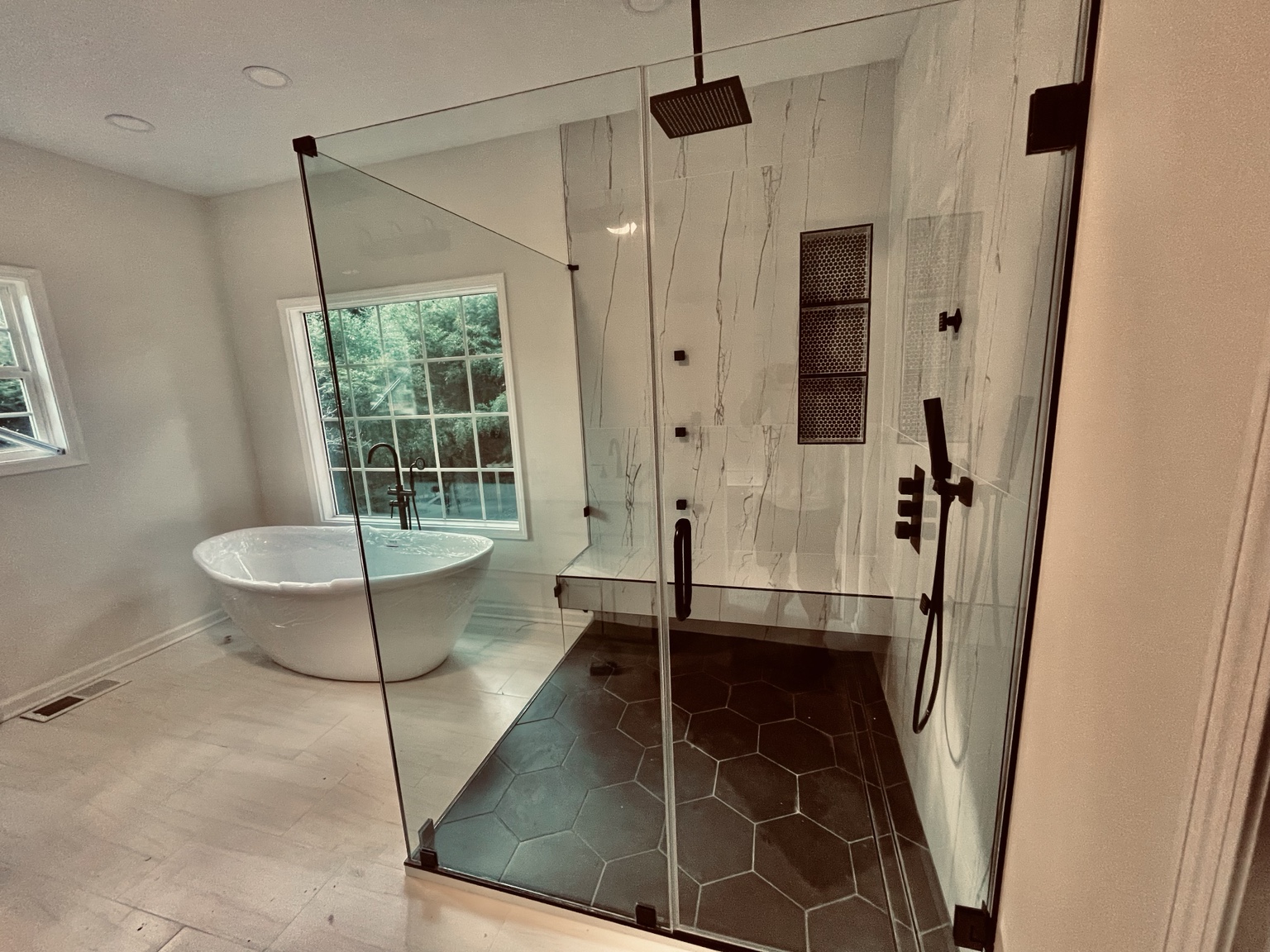 Bathroom remodel with glass shower and freestanding tub