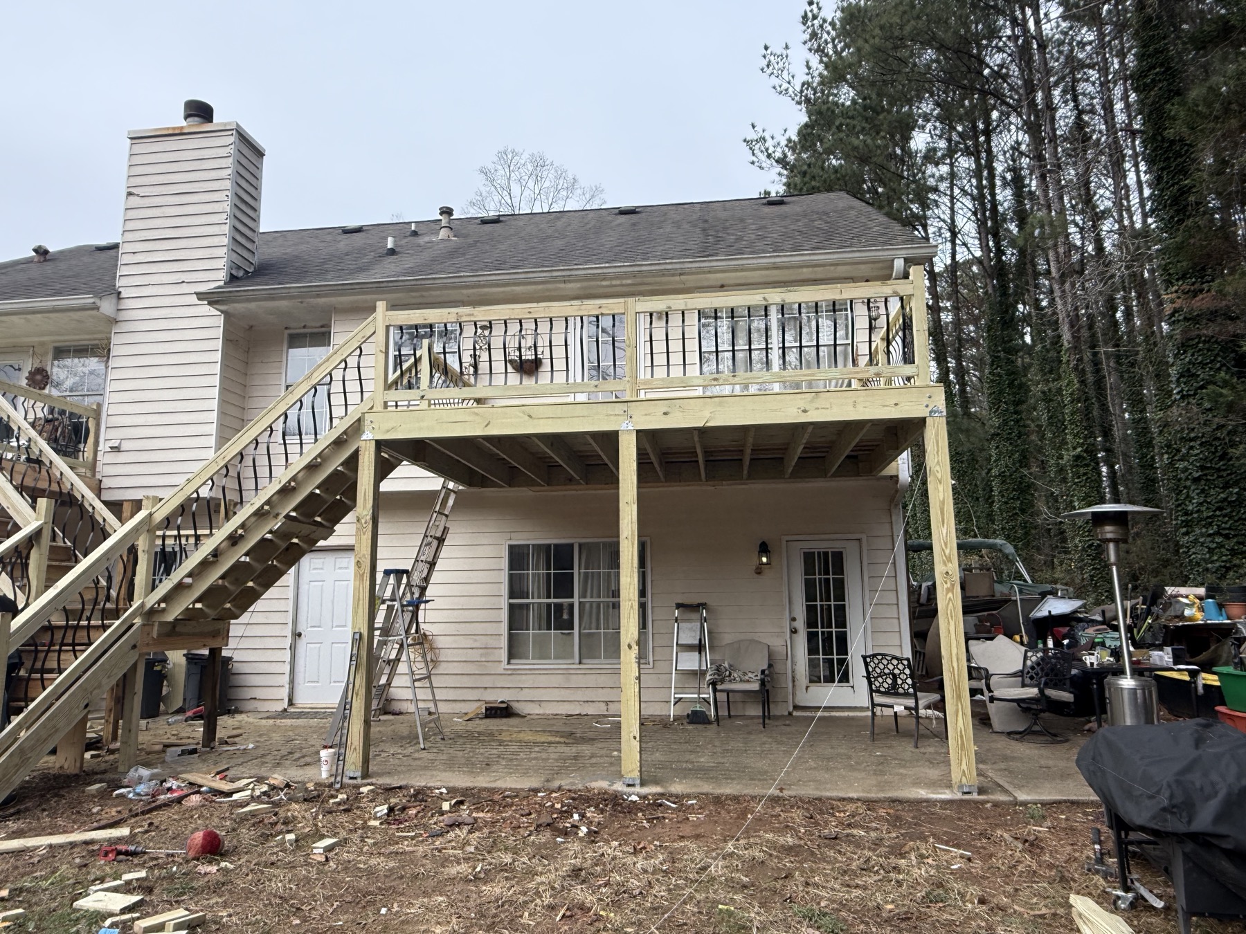 New deck with black rod railing and staircase after rebuild