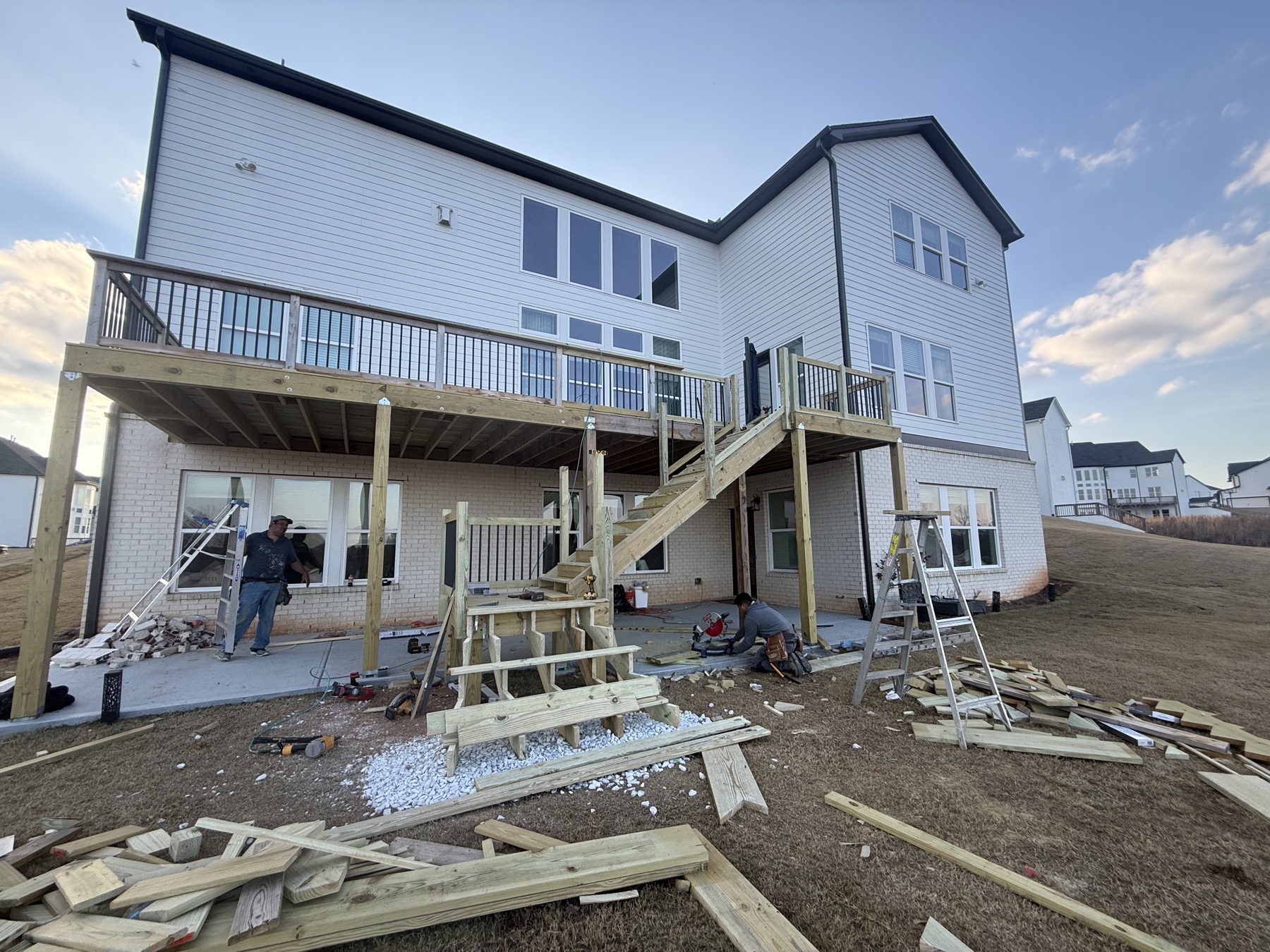 Finished elevated deck with pergola and stone patio